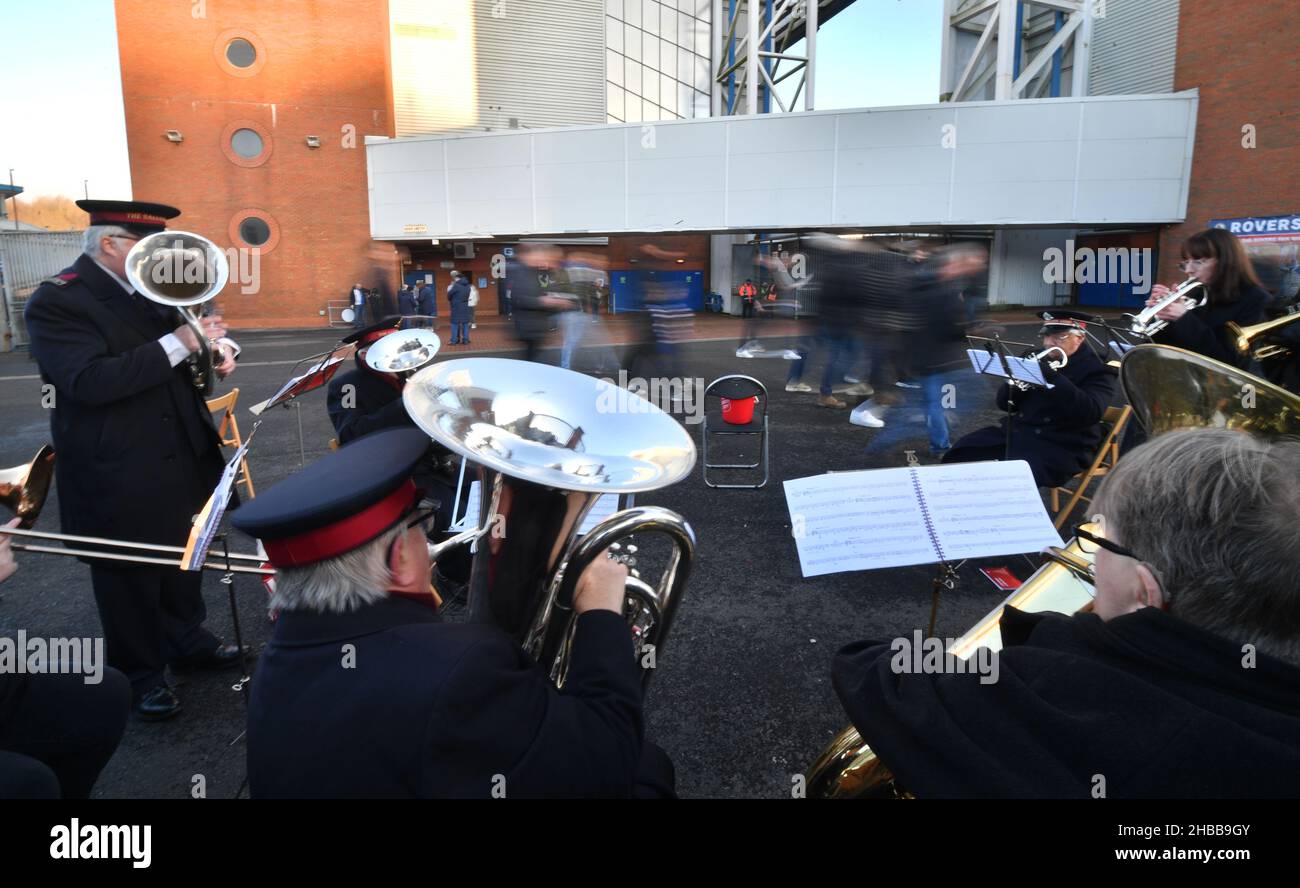 Fans walk past a band playing outside the ground ahead of the Sky Bet Championship match at Ewood Park, Blackburn. Picture date: Saturday December 18, 2021. Stock Photo
