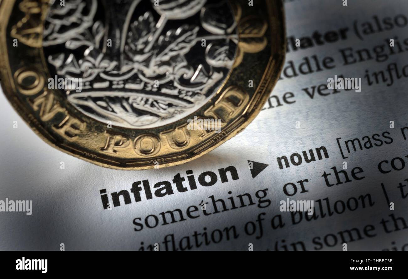 DICTIONARY DEFINITION OF THE WORD INFLATION WITH ONE POUND COIN RE MORTGAGES ECONOMY HOUSEHOLD BILLS ETC UK Stock Photo