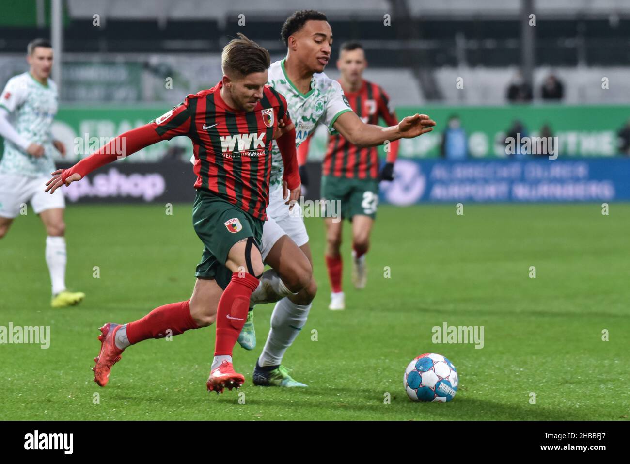Fuerth, Germany. 18th Dec, 2021.  Fussball, 1.Bundesliga - SpVgg Greuther Fuerth vs. FC Augsburg  Image: (fLTR) Carlos Gruezo (FC Augsburg, 8), Jamie Leweling (SpVgg Greuther Fürth,40)  DFL regulations prohibit any use of photographs as image sequences and or quasi-video Credit: Ryan Evans/Alamy Live News Stock Photo