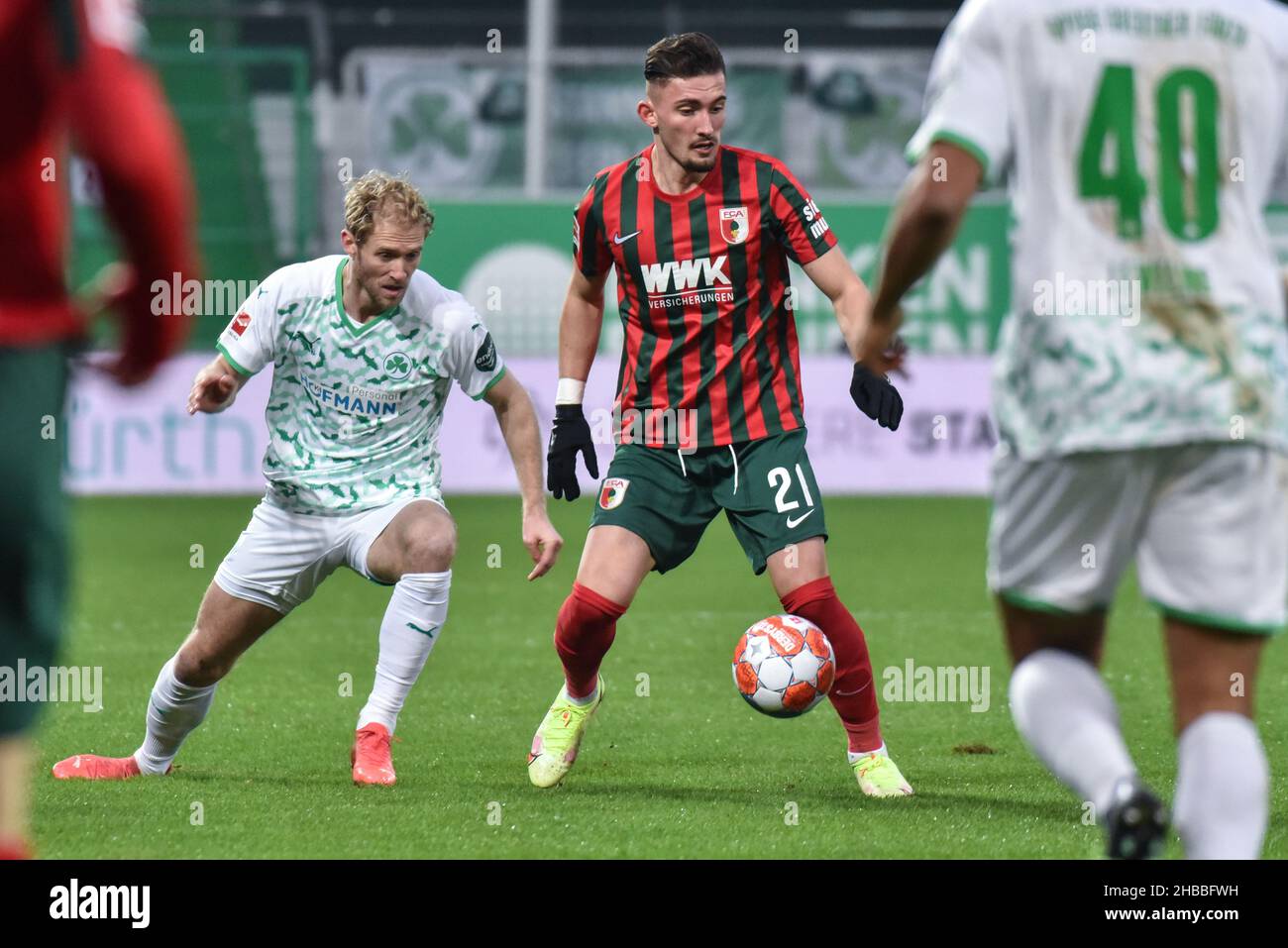 Fuerth, Germany. 18th Dec, 2021.  Fussball, 1.Bundesliga - SpVgg Greuther Fuerth vs. FC Augsburg  Image: (fLTR) Sebastian Griesbeck (SpVgg Greuther Fürth,22), Andi Zeqiri (FC Augsburg, 21)  DFL regulations prohibit any use of photographs as image sequences and or quasi-video Credit: Ryan Evans/Alamy Live News Stock Photo