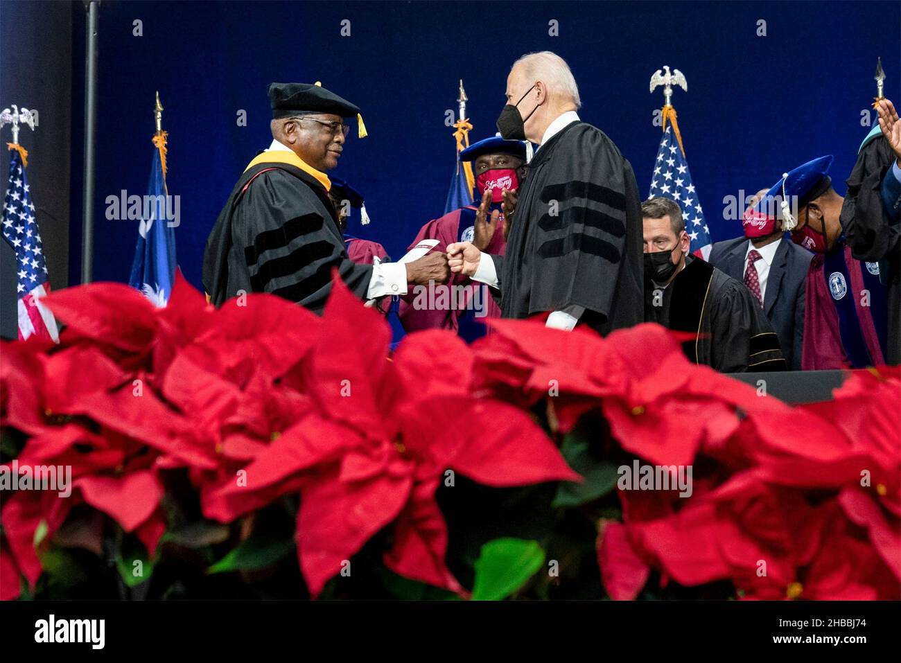 Orangeburg, USA. 17th Dec, 2021. Orangeburg, USA. 17 December, 2021. U.S President Joe Biden bumps fists with Rep. Jim Clyburn during the graduation ceremony at South Carolina State University December 17, 2021 in Orangeburg, South Carolina. Clyburn graduated from the university sixty years ago, but never had the chance to walk in the commencement ceremony. Credit: Erin Scott/White House Photo/Alamy Live News Stock Photo