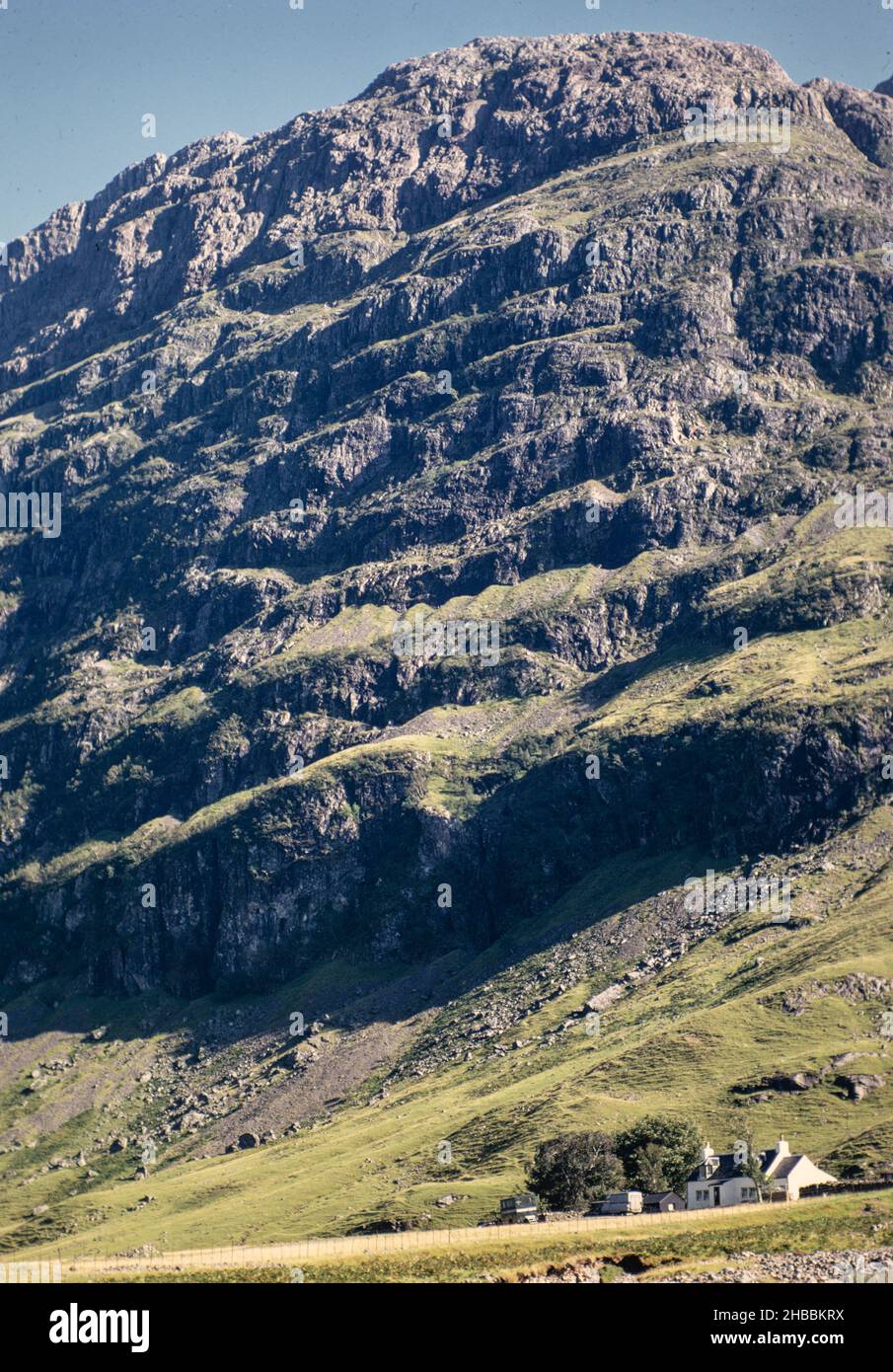 Archive image: The face of Aonach Dubh in Glencoe with Achtriochtan Cottage at its base, 1990, scanned from 35mm transparency Stock Photo