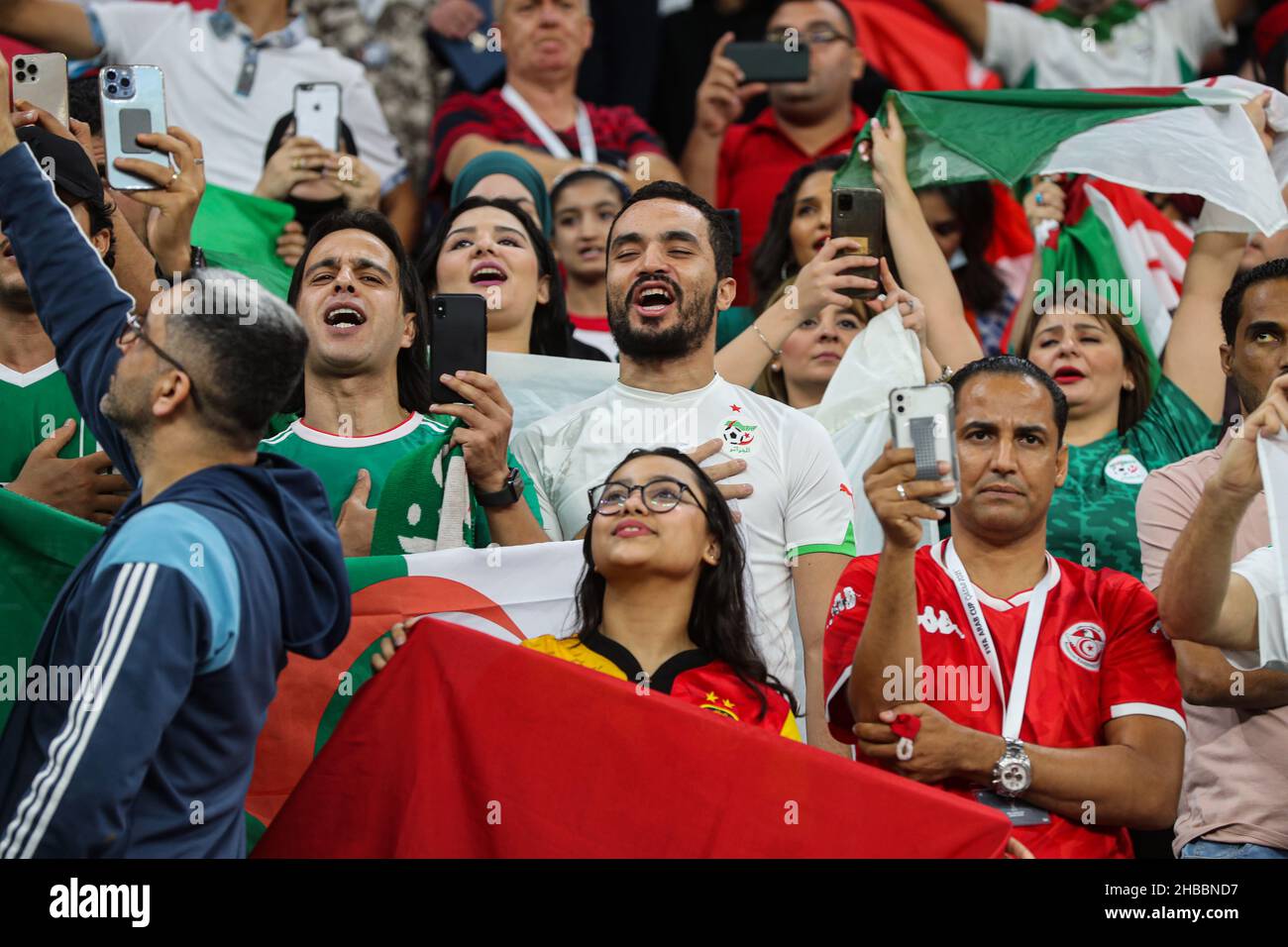 Al Khor, Qatar. 18th Dec, 2021. Fans cheer in the stands during the FIFA Arab Cup final soccer match between Tunisia and Algeria at Al Bayt Stadium. Credit: Mahmoud Hefnawy/dpa/Alamy Live News Stock Photo