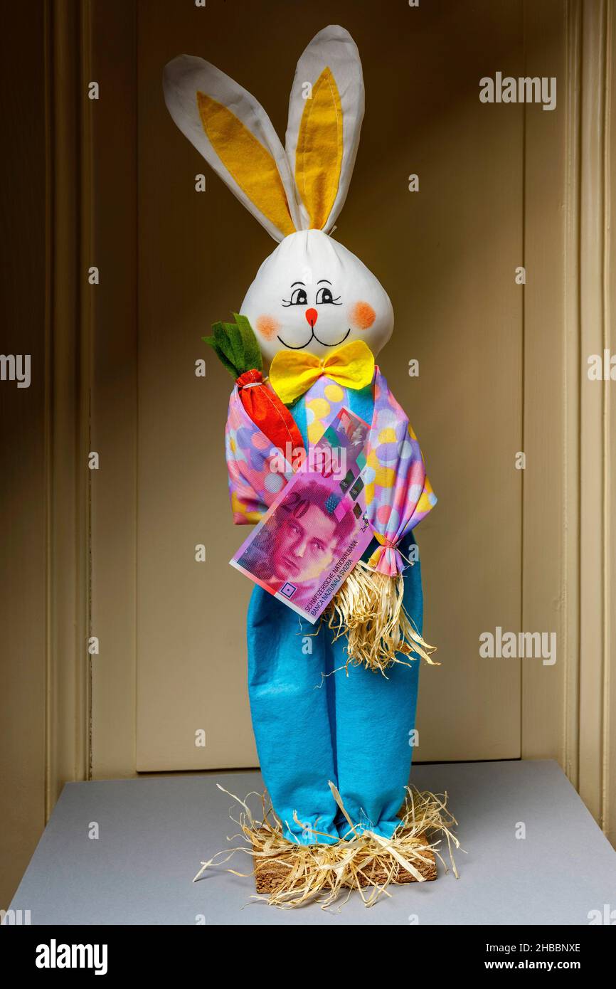 Stuffed happy rabbit holding a twenty Swiss Francs banknote Stock Photo ...