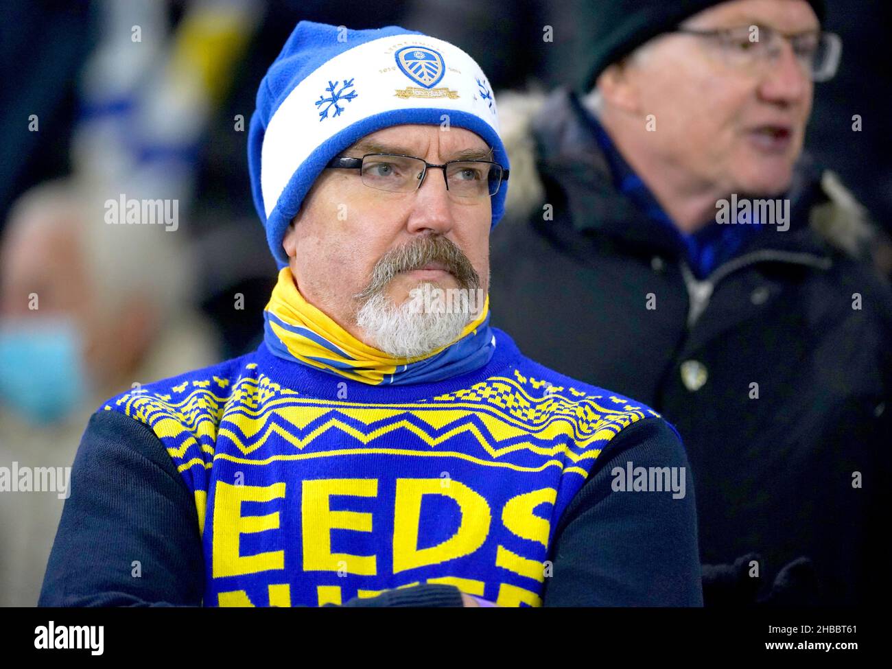 A Leeds United fan in the stands wearing a festive jumper and hat ahead of  the Premier League match at Elland Road, Leeds. Picture date: Saturday  December 18, 2021 Stock Photo - Alamy