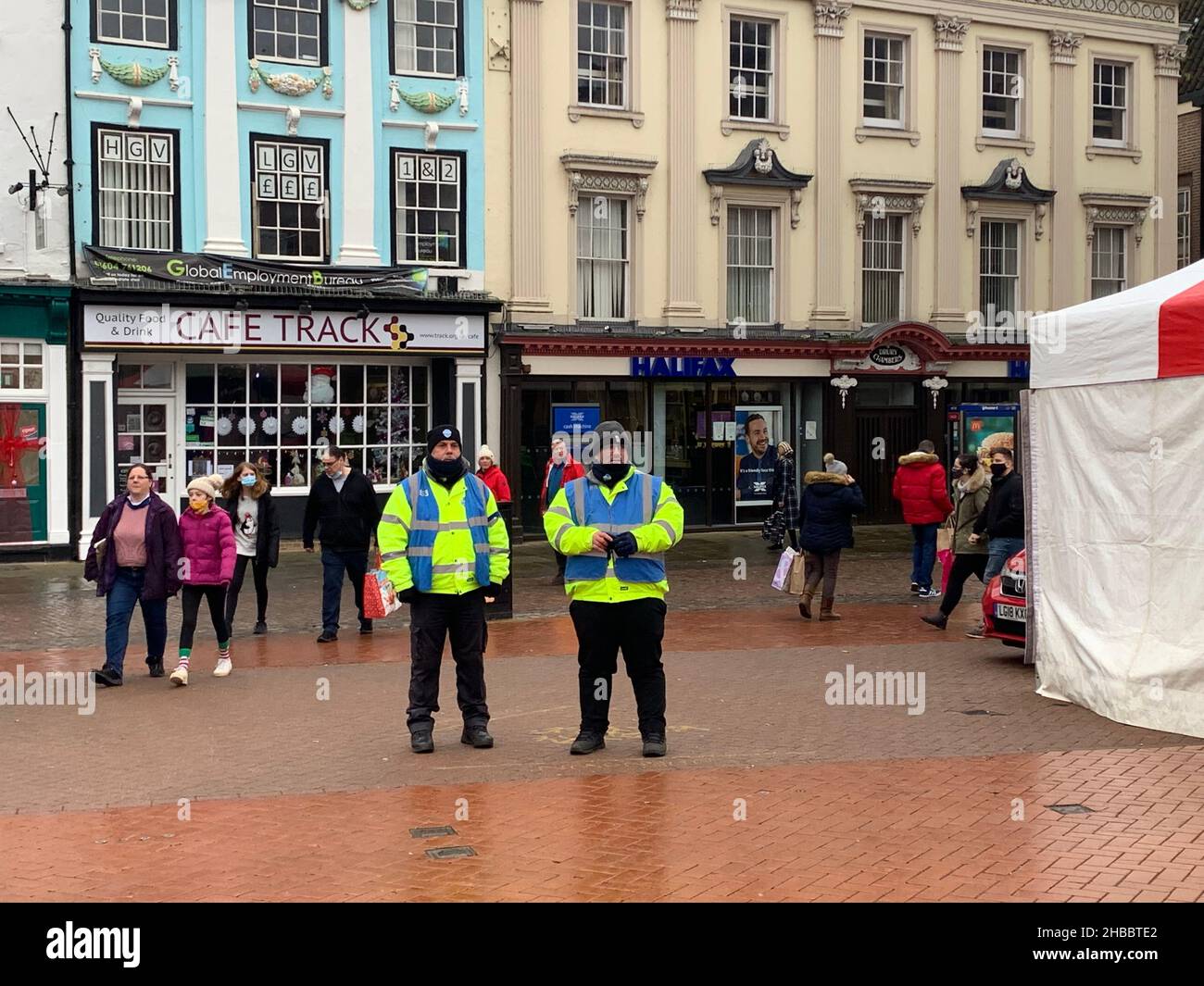 Halifax Building society and two policemen on Market Square Northampton UK police officers officer rain raining old style buildings ancient weather Stock Photo