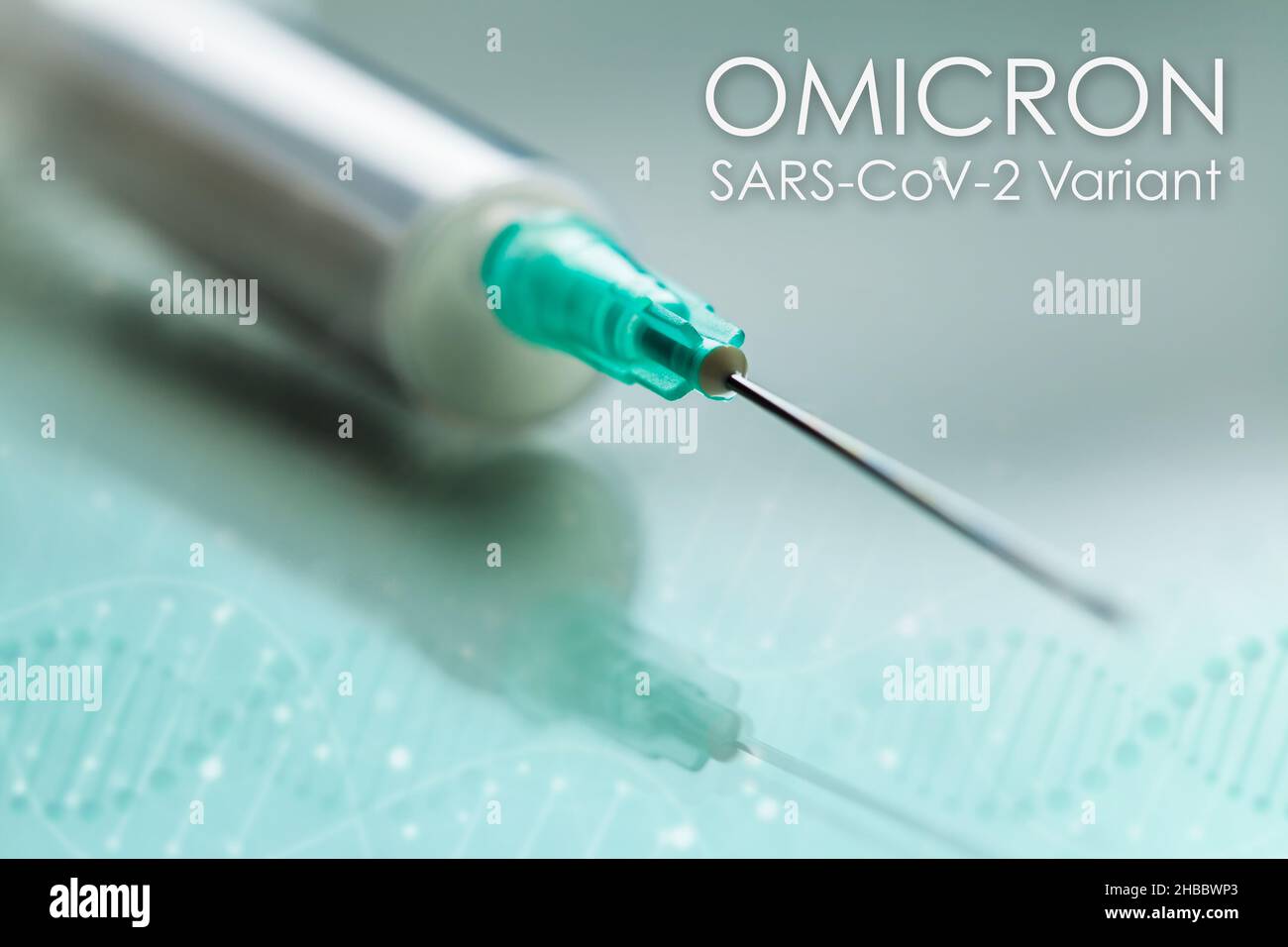 White syringe with green needle on reflective background,concept of vaccination and immunization against SARS-CoV-2 OMICRON variant,new mutant strain Stock Photo