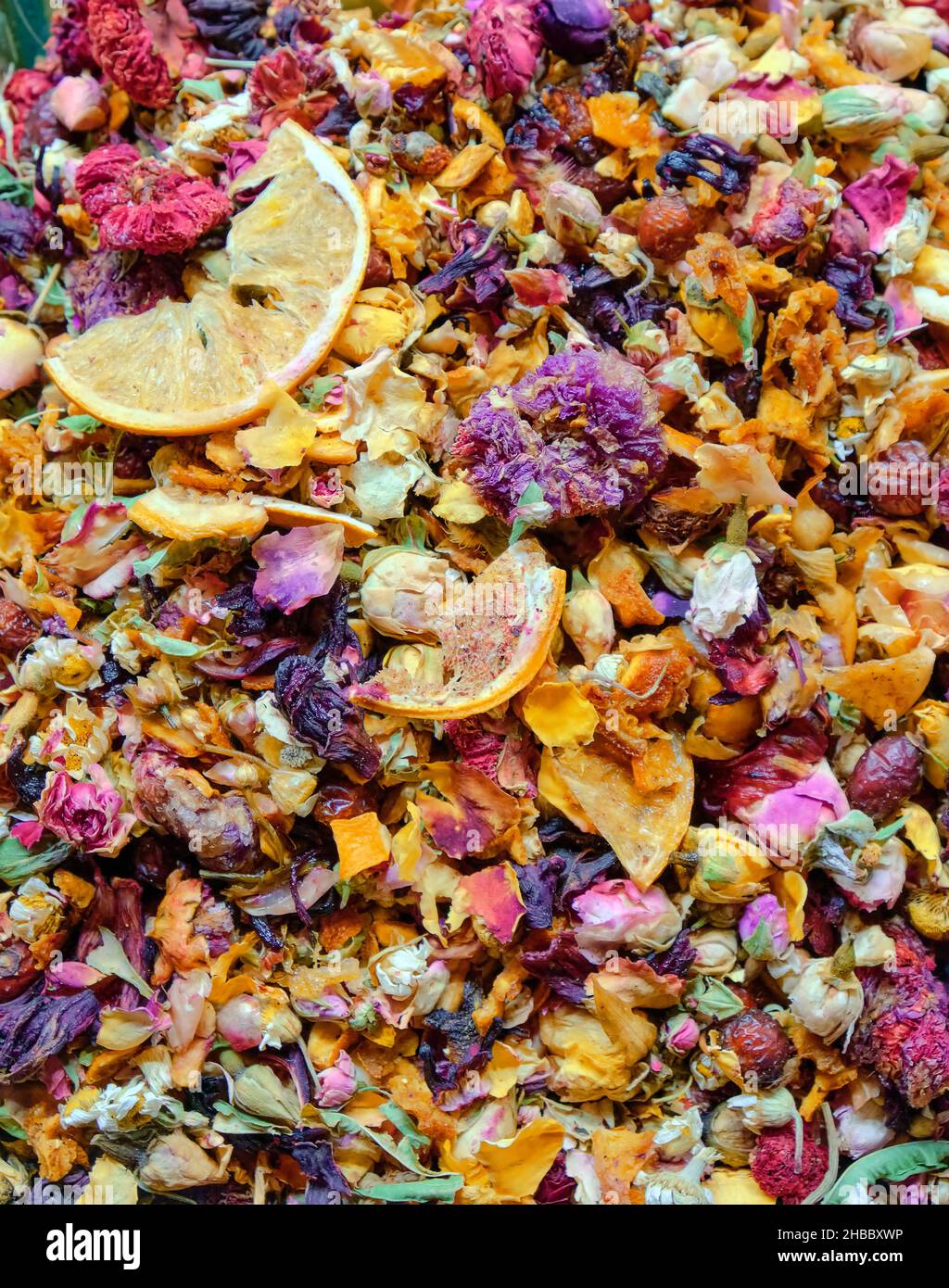 Food background texture of herbal tea with flowers buds and petals and citrus pieces, organic healthy detox tea. Stock Photo