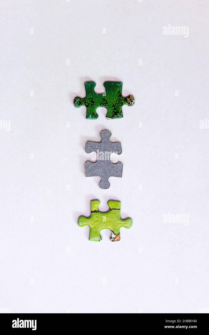 three puzzle pieces on a light background Stock Photo