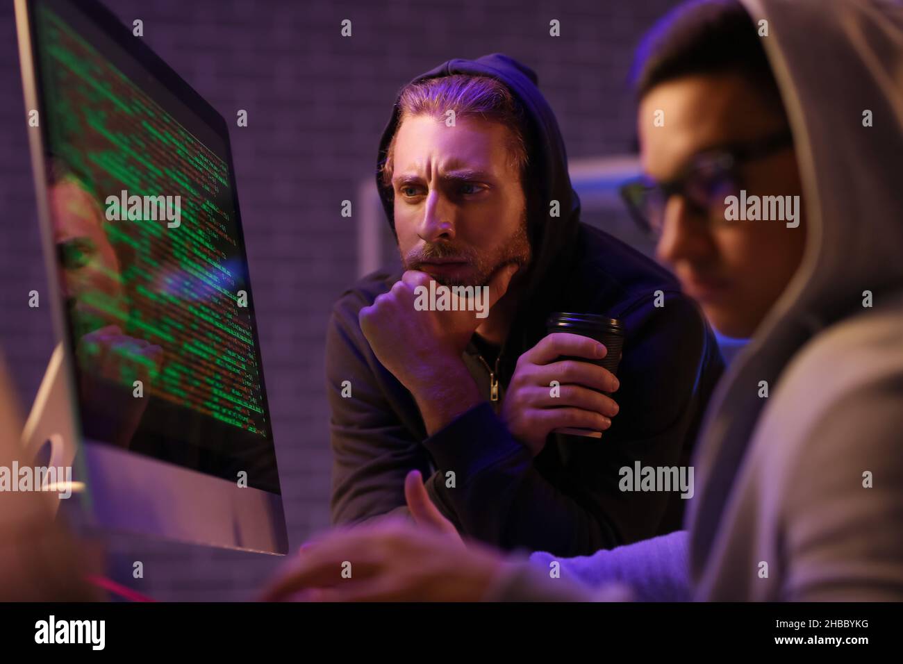 Hackers using computer in dark room Stock Photo - Alamy
