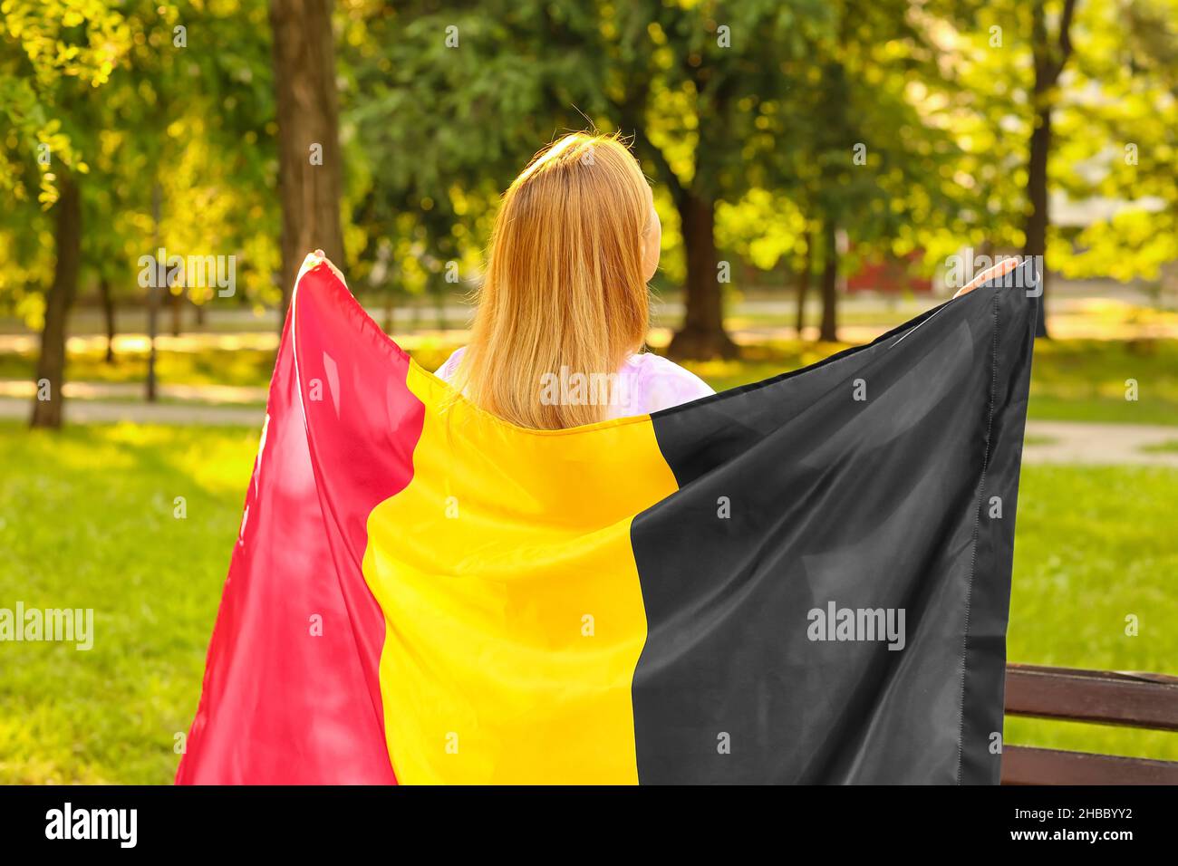 Mature woman with flag of Belgium in park Stock Photo - Alamy