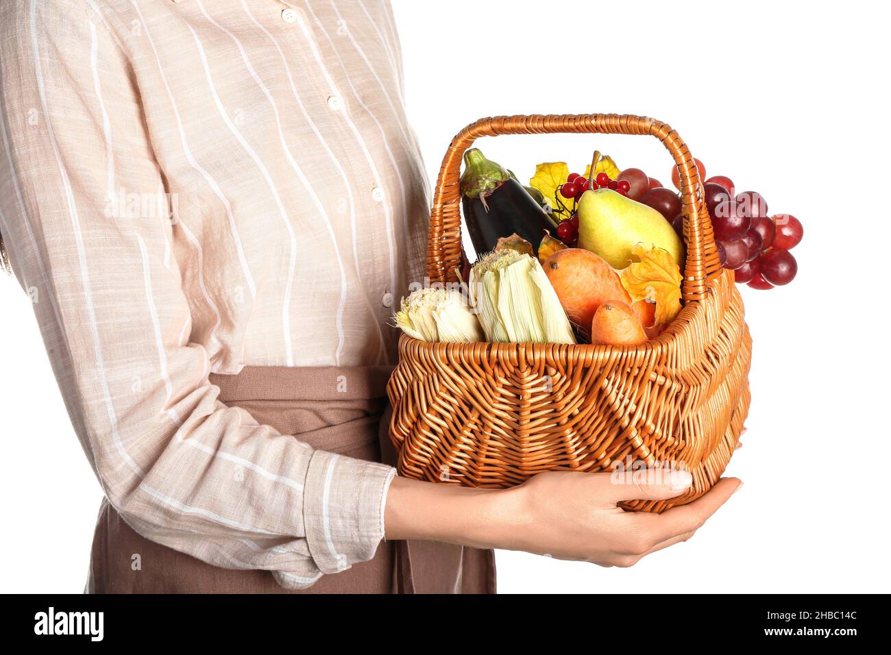 Woman holding basket with different healthy food on white background ...