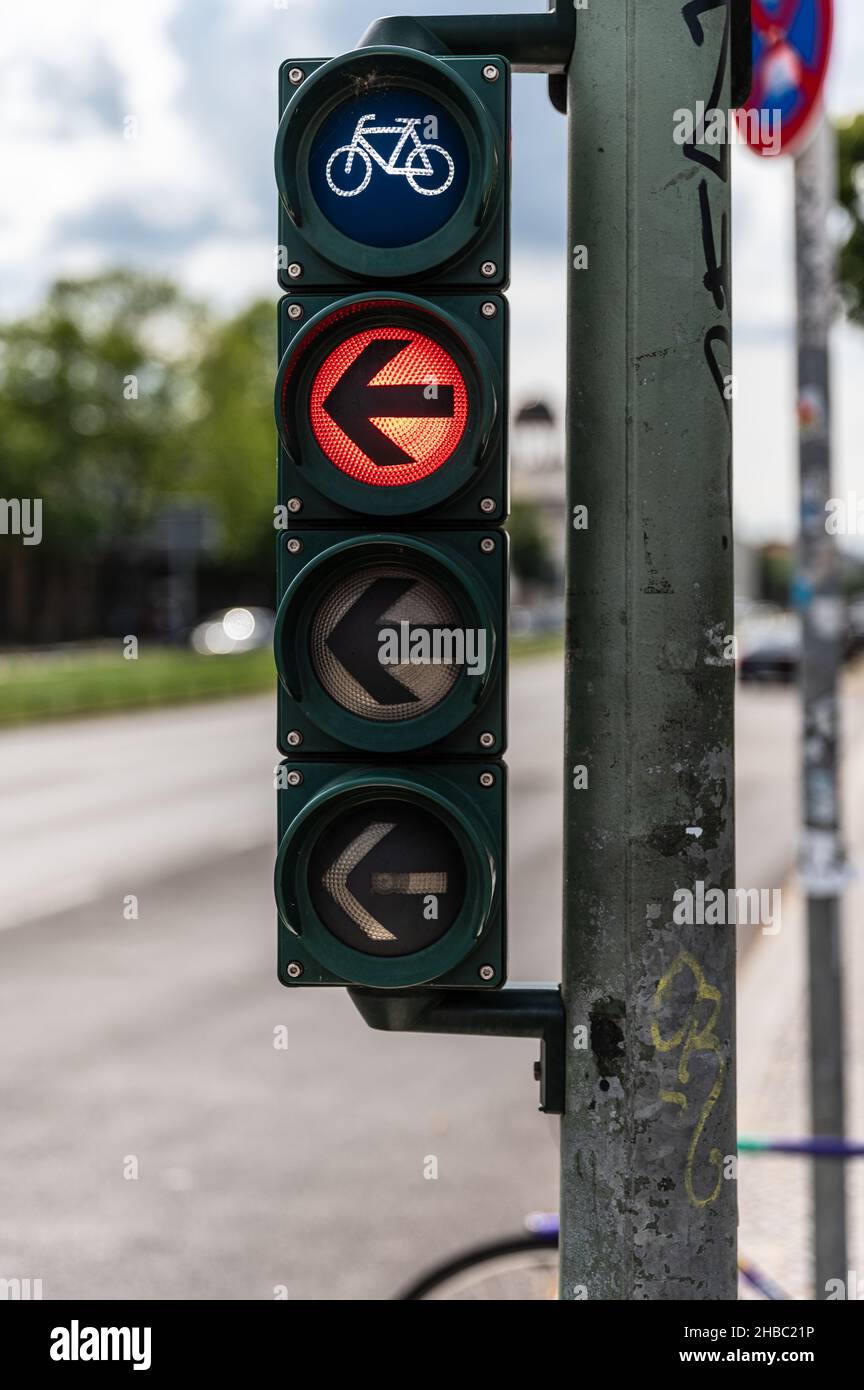 Bicycle traffic light with red light and arrow pointing to the left Stock Photo