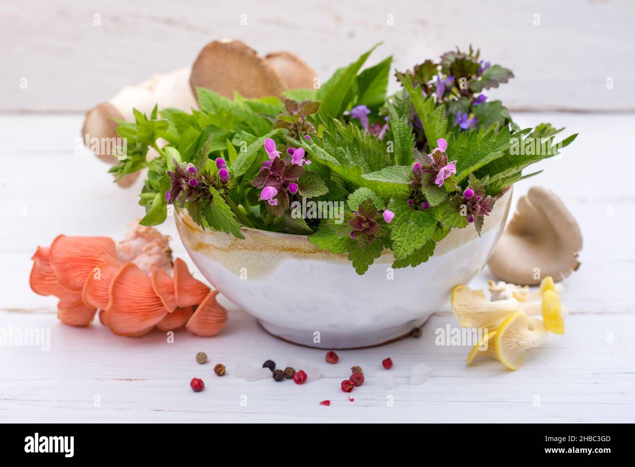 Bowl of fresh wild herbs and mushrooms Stock Photo