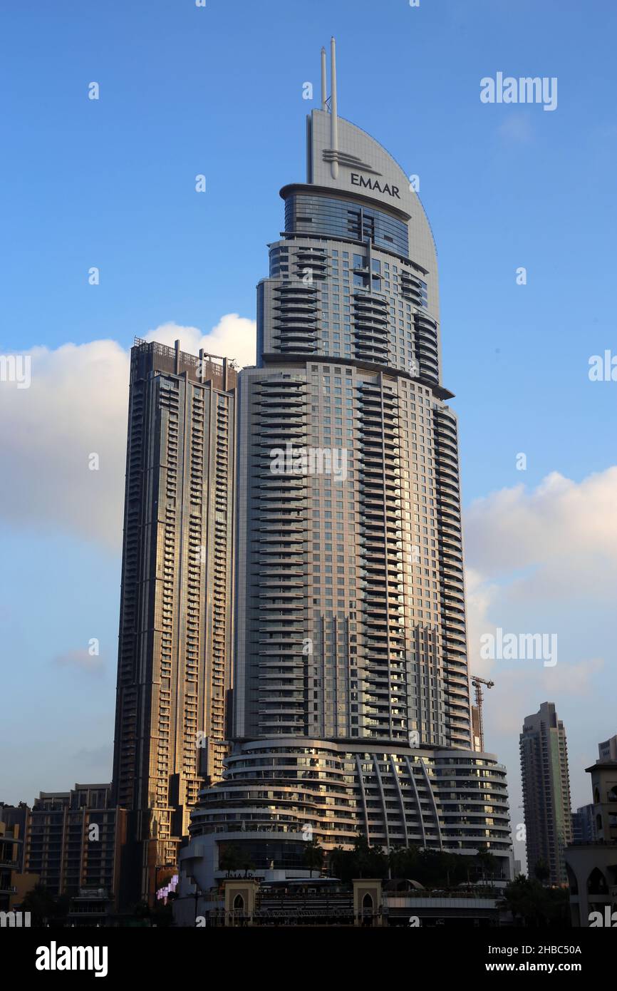 Emaar glass skyscraper buildings near Dubai Mall during sunny day with blue sky and some clouds. Color image from Dubai, UAE, December 2019. Stock Photo