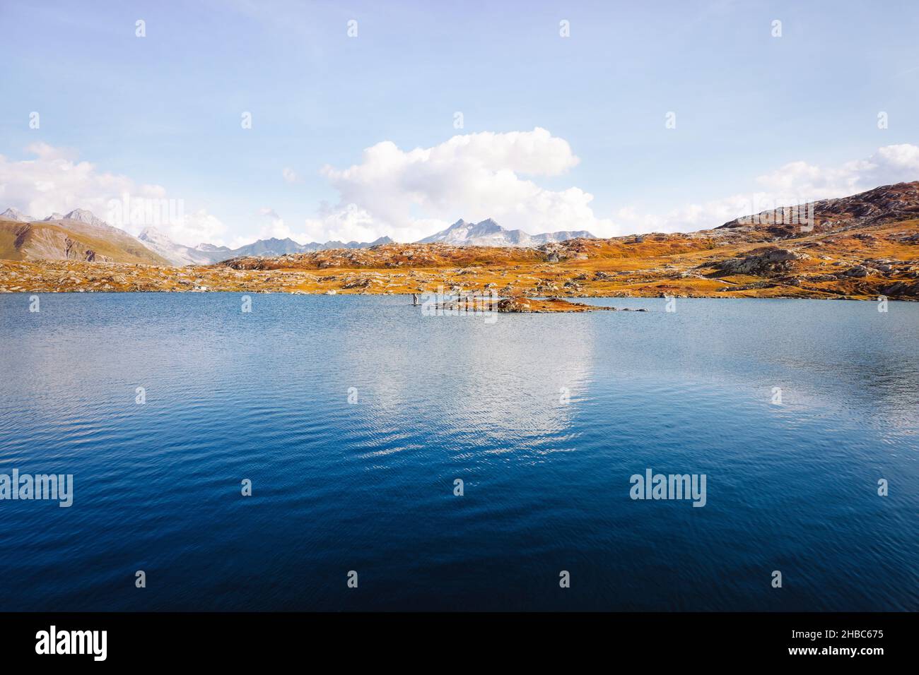 Dark blue waters of scenic mountain lake in the Swiss Alps. Totesee, Totensee at the Grimsel Pass in Switzerland, Canton of Valais. Stock Photo