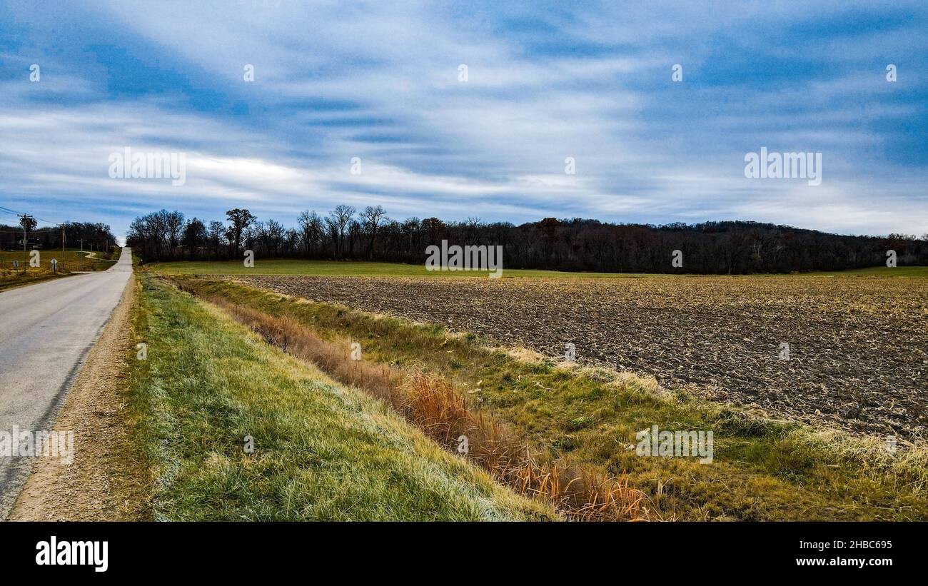 Roadside view of agricultural field and blue sky Stock Photo