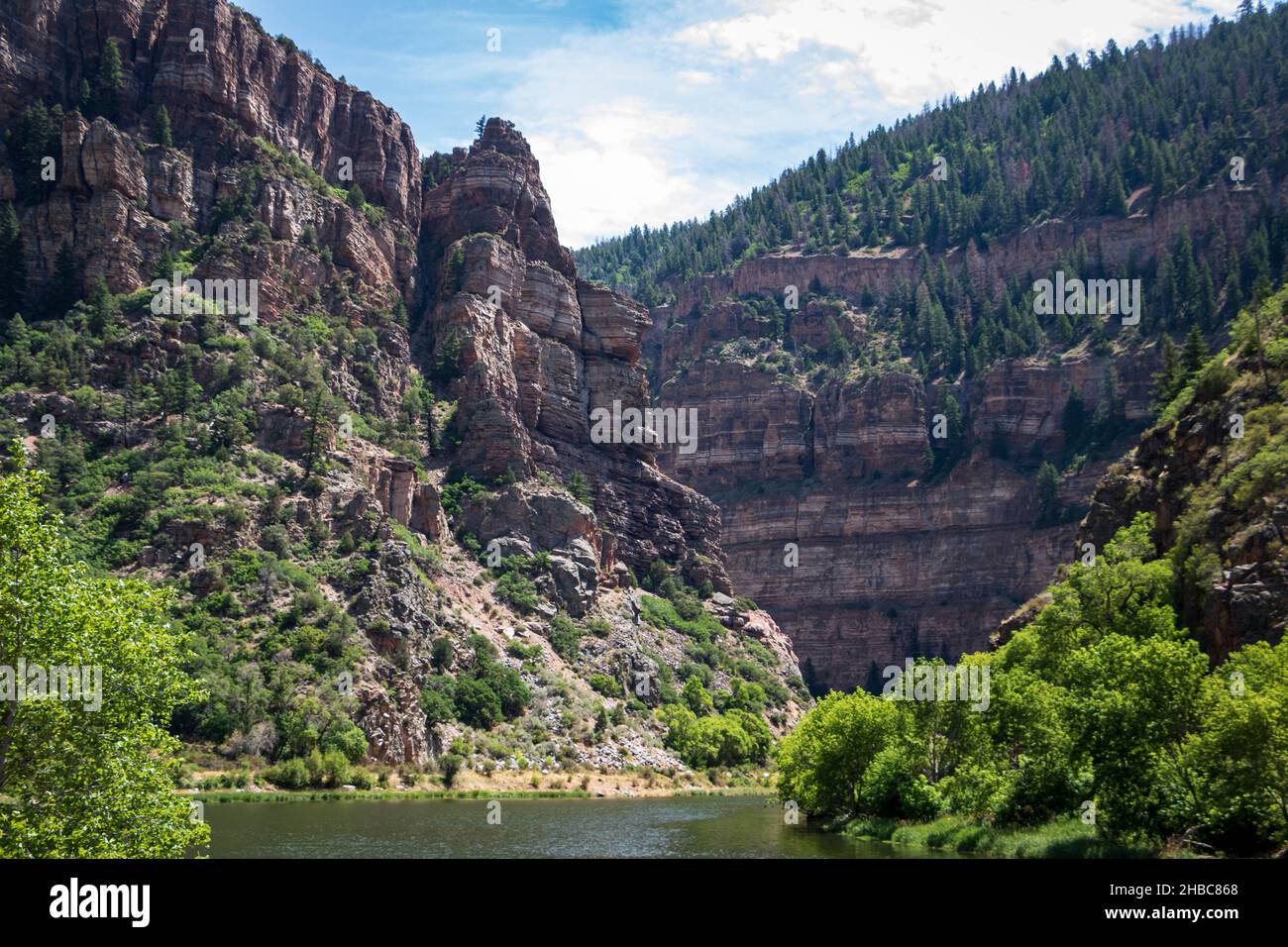 Scenic view of rock stratum in Glenwood Canyon with the Colorado River  below, on a sunny summer day. Glenwood Springs, Colorado, USA Stock Photo