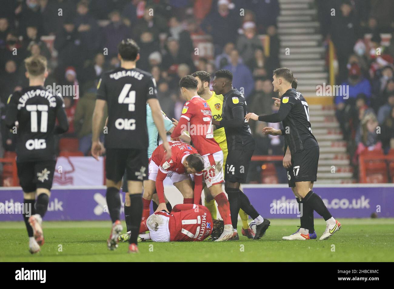 Nottingham, UK. 18th Dec 2021. Alex Mighten of Nottingham Forest lays injured in the Hull City penalty area after being fouled by George Honeyman of Hull City resulting in a penalty being awarded during the Sky Bet Championship match between Nottingham Forest and Hull City at the City Ground, Nottingham on Saturday 18th December 2021. (Credit: James Holyoak | MI News) Credit: MI News & Sport /Alamy Live News Stock Photo