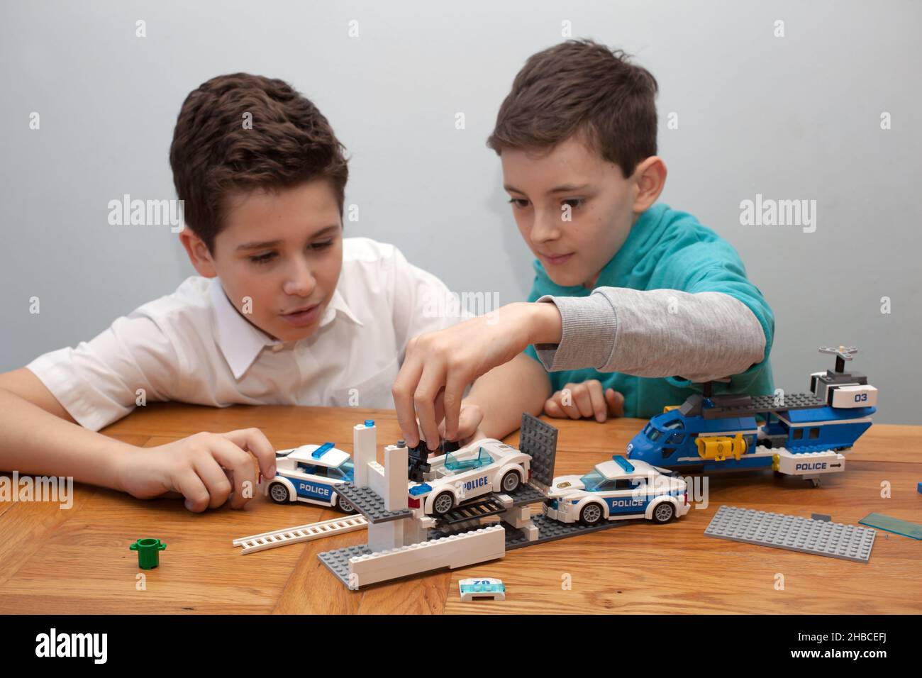 Two boys playing with Lego together Stock Photo