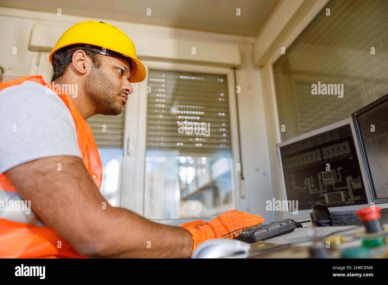 Young construction industry worker is working indoors Stock Photo