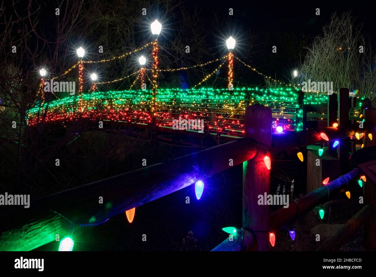 Colorful Christmas lights on Billy Drew Bridge on Clear Creek Trail
