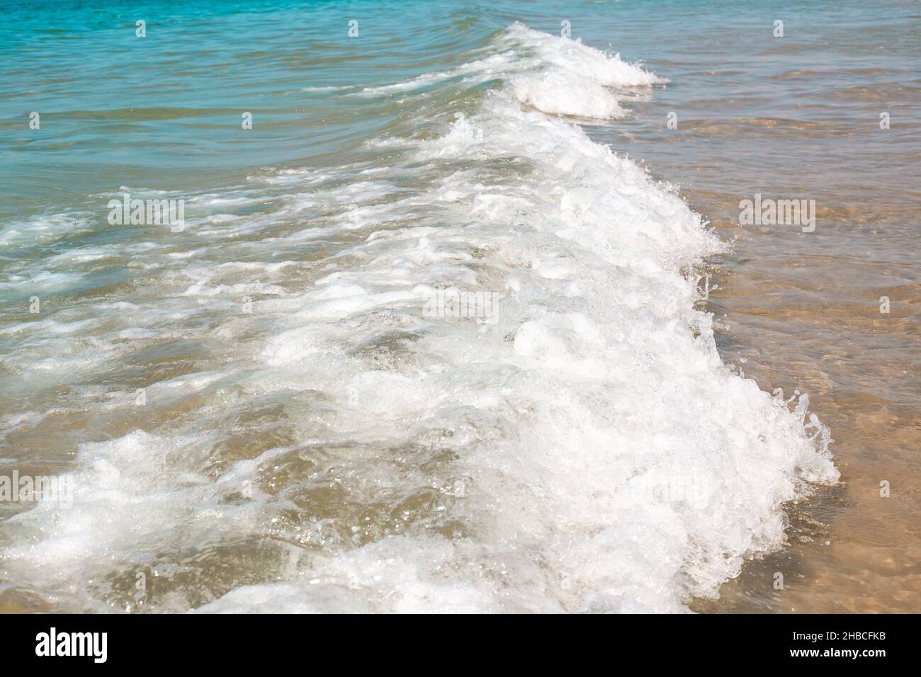 Sea wave with white foam on the sandy shore. Travel and tourism Stock ...