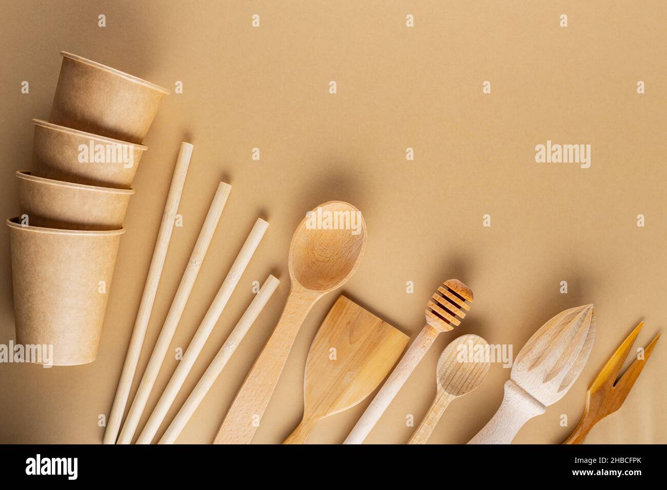 Set of eco friendly wooden bamboo cutlery on beige background. Plastic ...