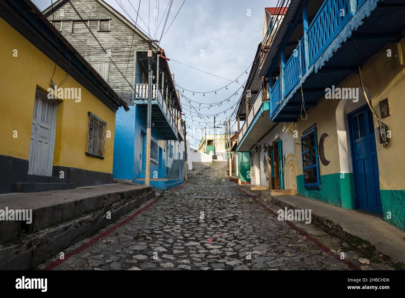 Colonial cobblestone street with colorful painted houses in Flores, Peten, Guatemala Stock Photo