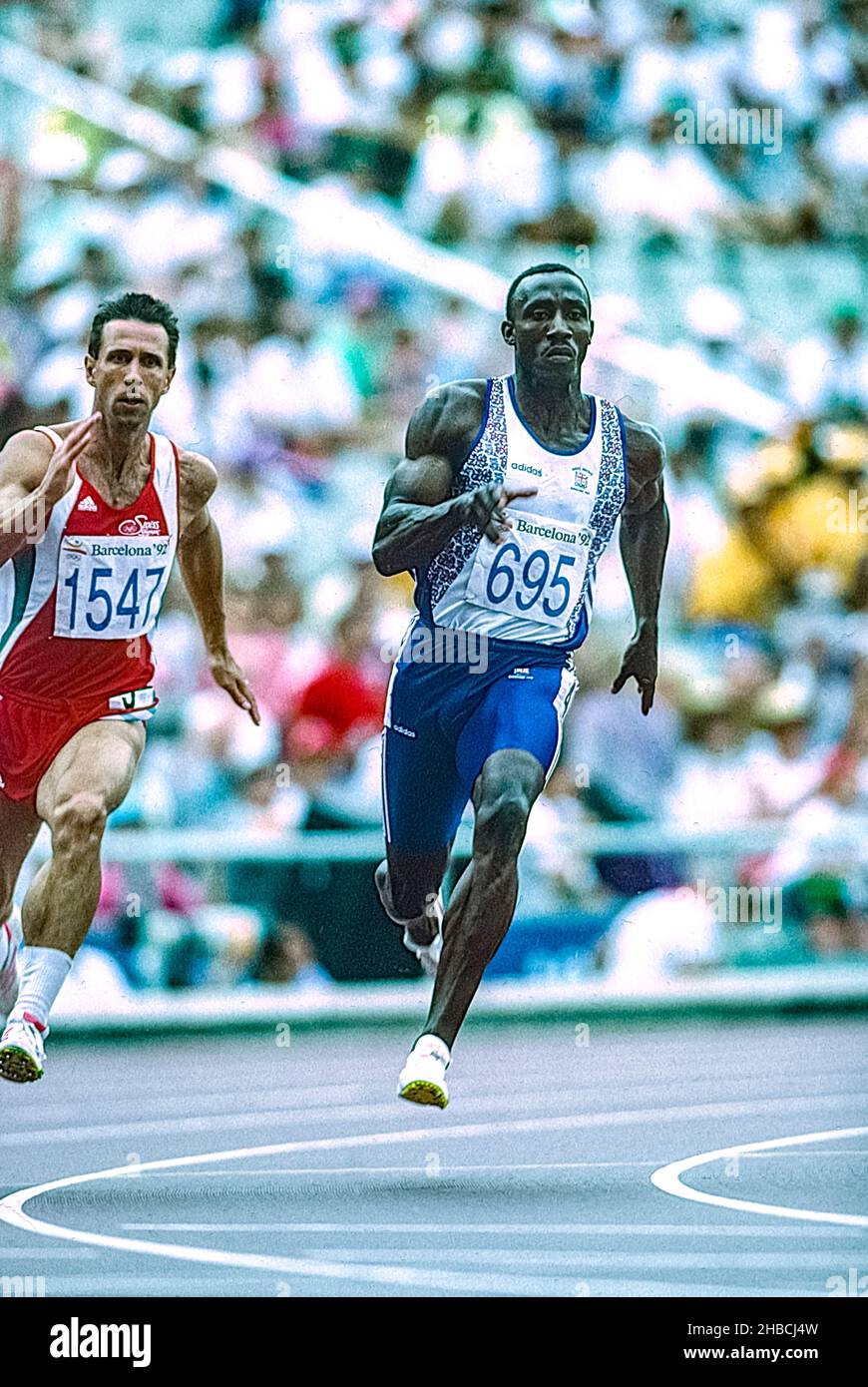 Linford Christie (GBR) #695 and Stefan Burkart (SUI) #1547 competing in the men's 200m R1 at the 1992 Olympic Summer Games. Stock Photo