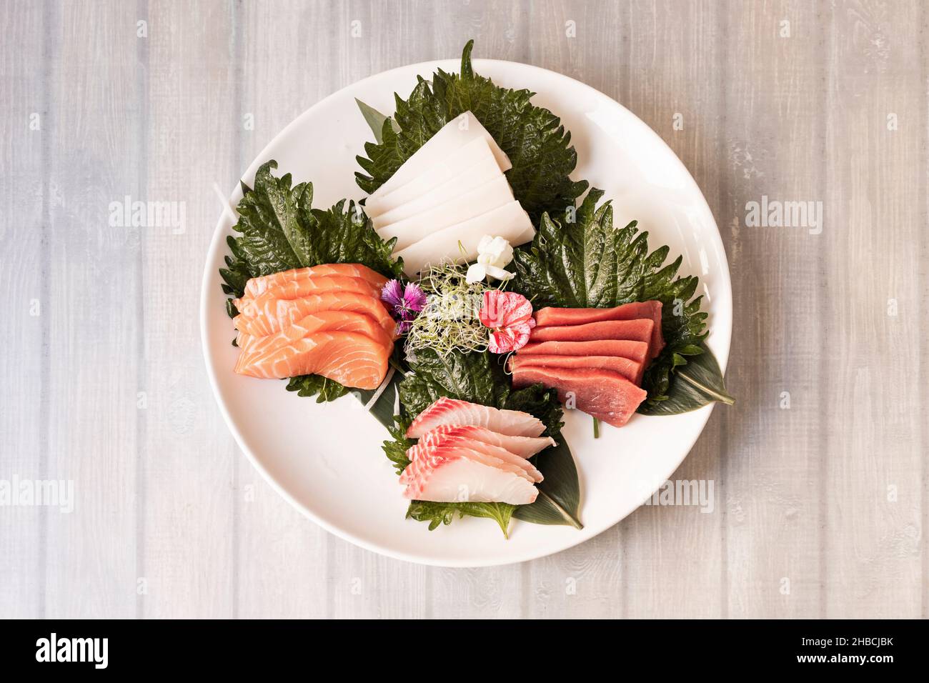 Assorted round sushi plate of Norwegian salmon sashimi, butterfish