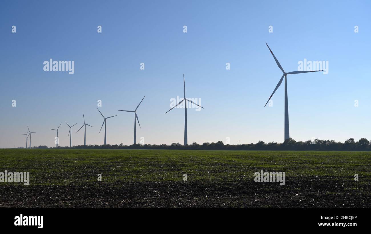 Wind turbines on blue sky background Stock Photo - Alamy