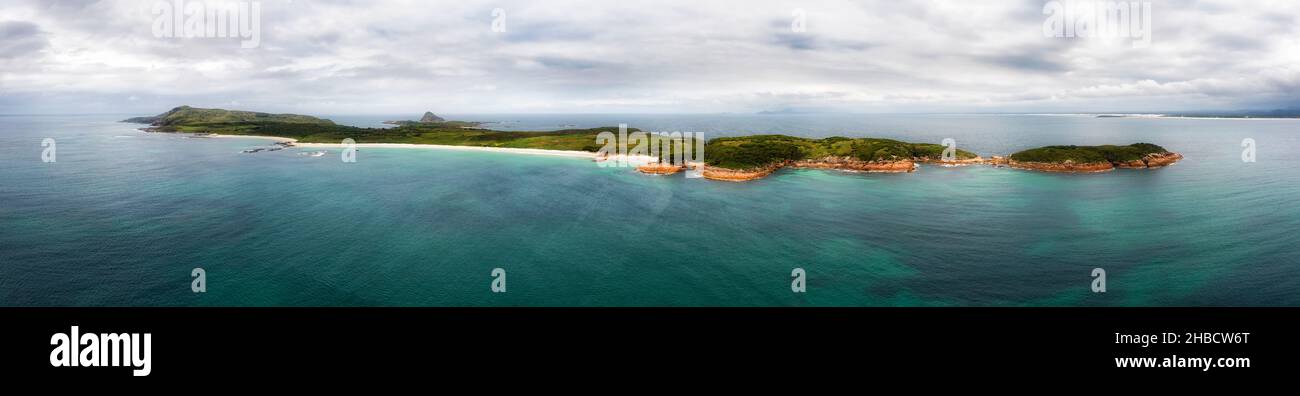 Chain of Broughton island on Pacific coast of Australia in wide aerial seascape panorama. Stock Photo