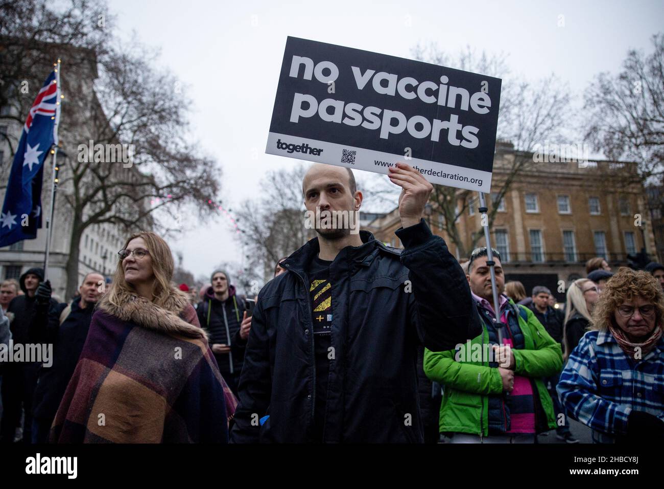 A protester is seen holding a placard of "no vaccine passports" during the demonstration. Following the introduction of covid 19 vaccination passport as part of the measures to limit the spread of Omicron covid 19 variant in the UK last week, people walk on the street to protest against the mandatory covid 19 vaccination and the use of covid 19 vaccination passport as part of the covid 19 restrictions. They demanded the "freedom" to choose to be vaccinated or not and not to be restricted by the covid 19 vaccination passport. Stock Photo