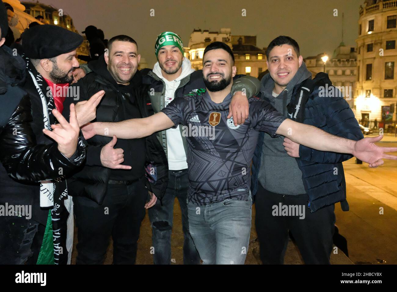 London, UK, 18th Dec, 2021. Hundreds of Algeria football fans gather in Trafalgar Square after a 2-0 victory against Tunisia in the 2021 FIFA Arab Cup, scoring the goals in extra-time.  Revellers set off dozens upon dozens of fireworks and flares in the square and at the foot of Nelson's Column - a location traditionally known for celebrating football fans. Credit: Eleventh Hour Photography/Alamy Live News Stock Photo