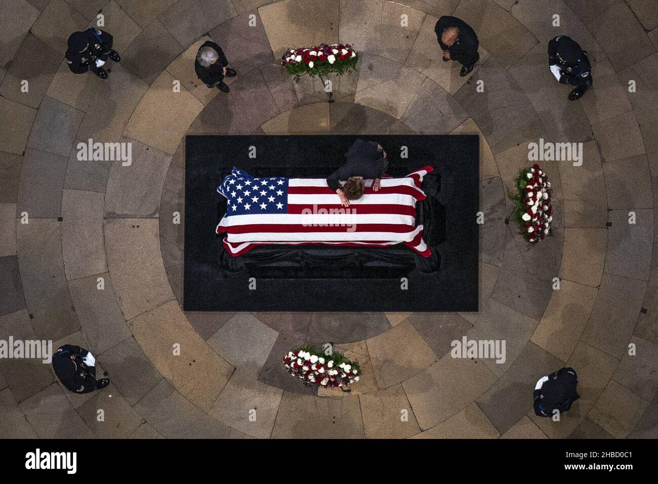 Washington, United States. 18th Dec, 2021. Elizabeth Dole lies across her husband's casket, former Senator Bob Dole (R-KS), as he lies in state during a Congressional memorial service in the Rotunda at the U.S. Capitol in Washington DC, on Thursday, December 9, 2021. Dole, who served on Capitol Hill for 36 years, died in his sleep on December 5 at the age of 98. Pool photo by Andrew Harnik/UPI Credit: UPI/Alamy Live News Stock Photo