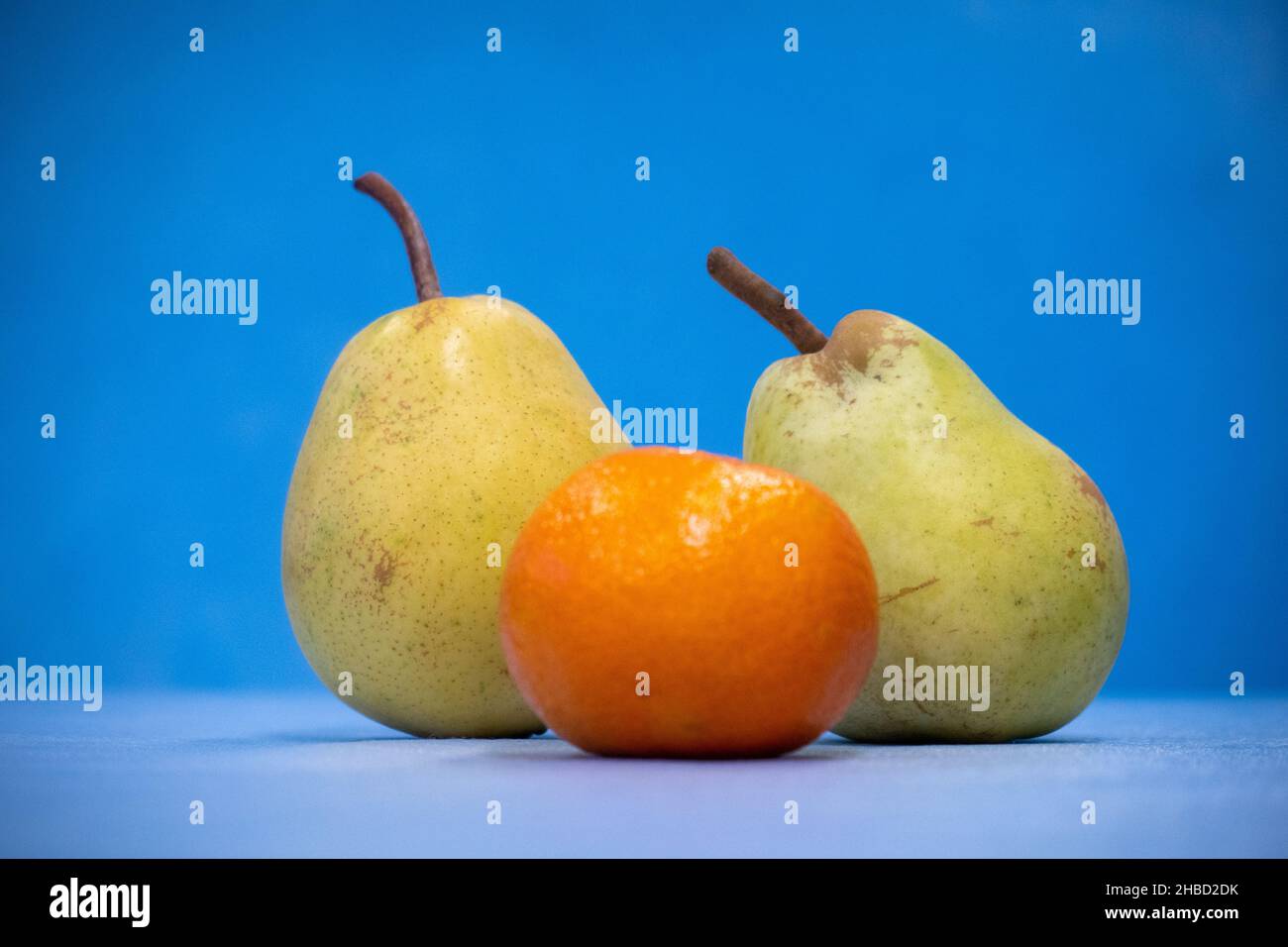Biten Pear a close up of a bitten pear is standing and the background is blue ...