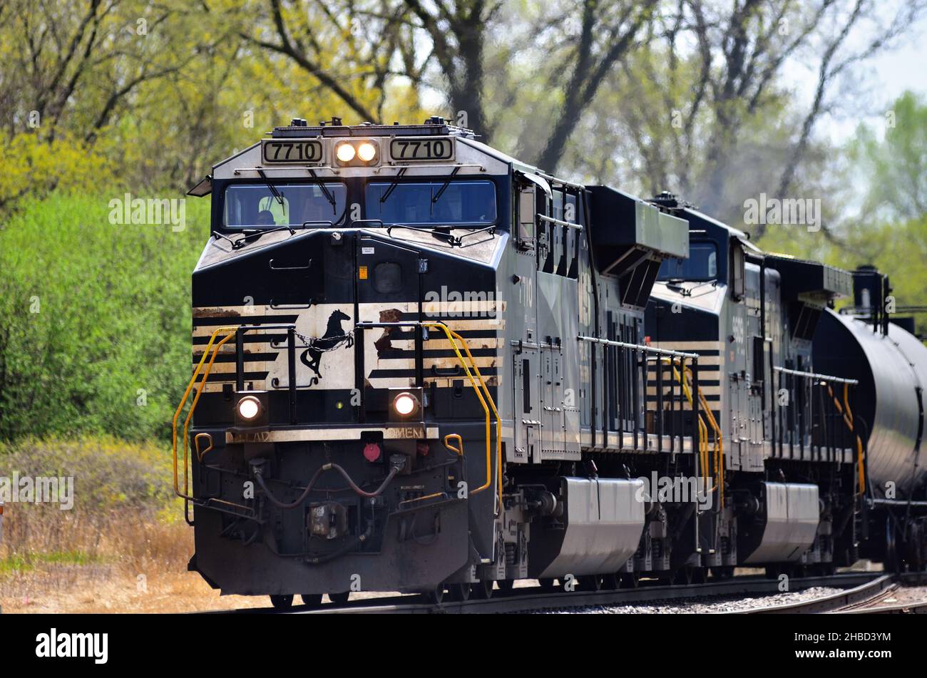 Hoffman Estates, Illinois, USA. A pair of Norfolk Southern Railway locomotives lead a Canadian National Railway freight train. Stock Photo