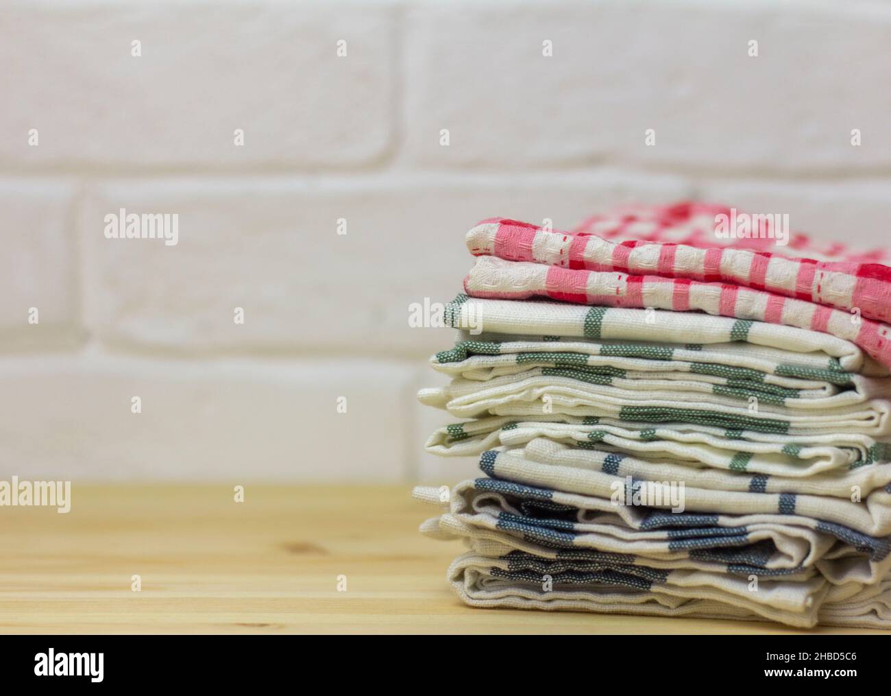 A stack of clean kitchen towels on the table Stock Photo