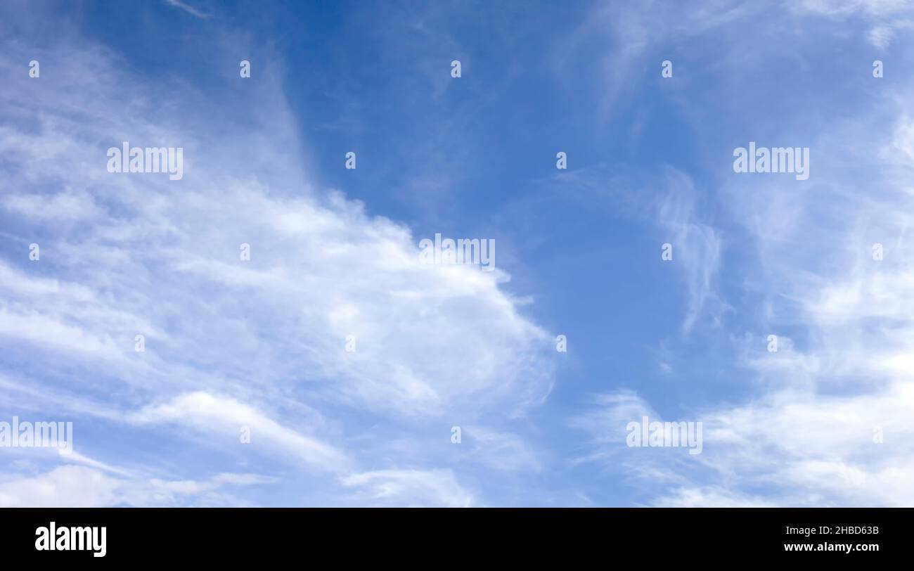 Panorama of white soft blurred clouds on a background of blue sky. Stock Photo
