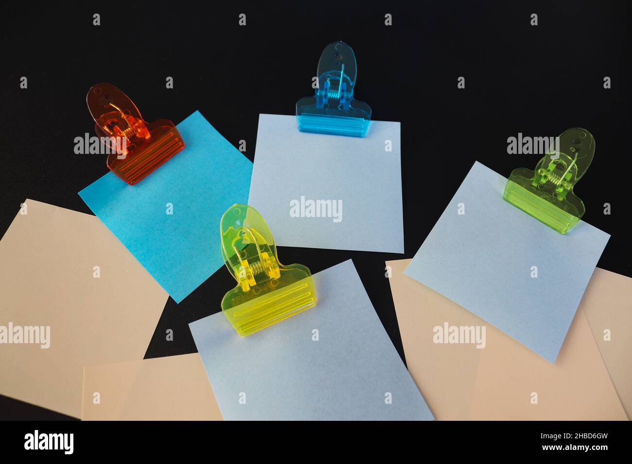 Post it notes with clips on dark background Stock Photo - Alamy