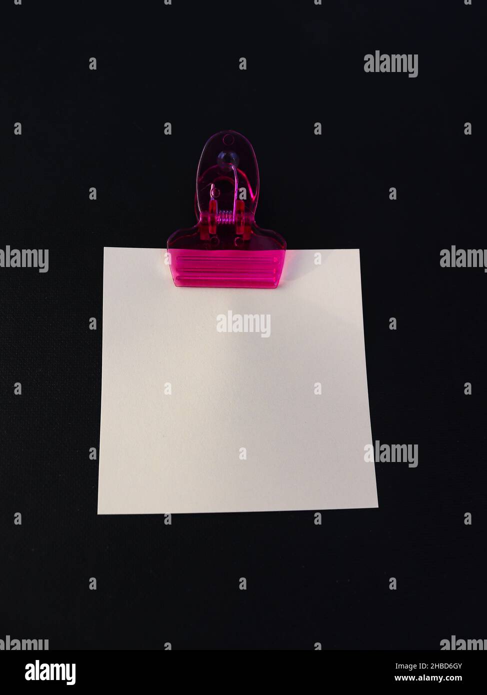 Post it note with clip on dark background Stock Photo - Alamy