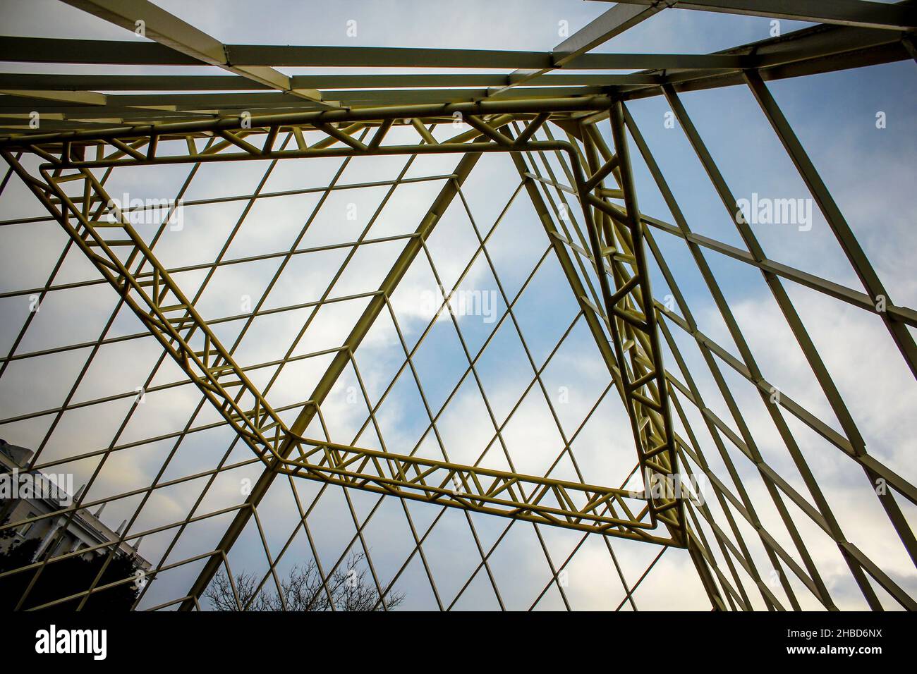 An unfinished and abandoned metal pyramid shaped building. Iron structure inside view. Stock Photo
