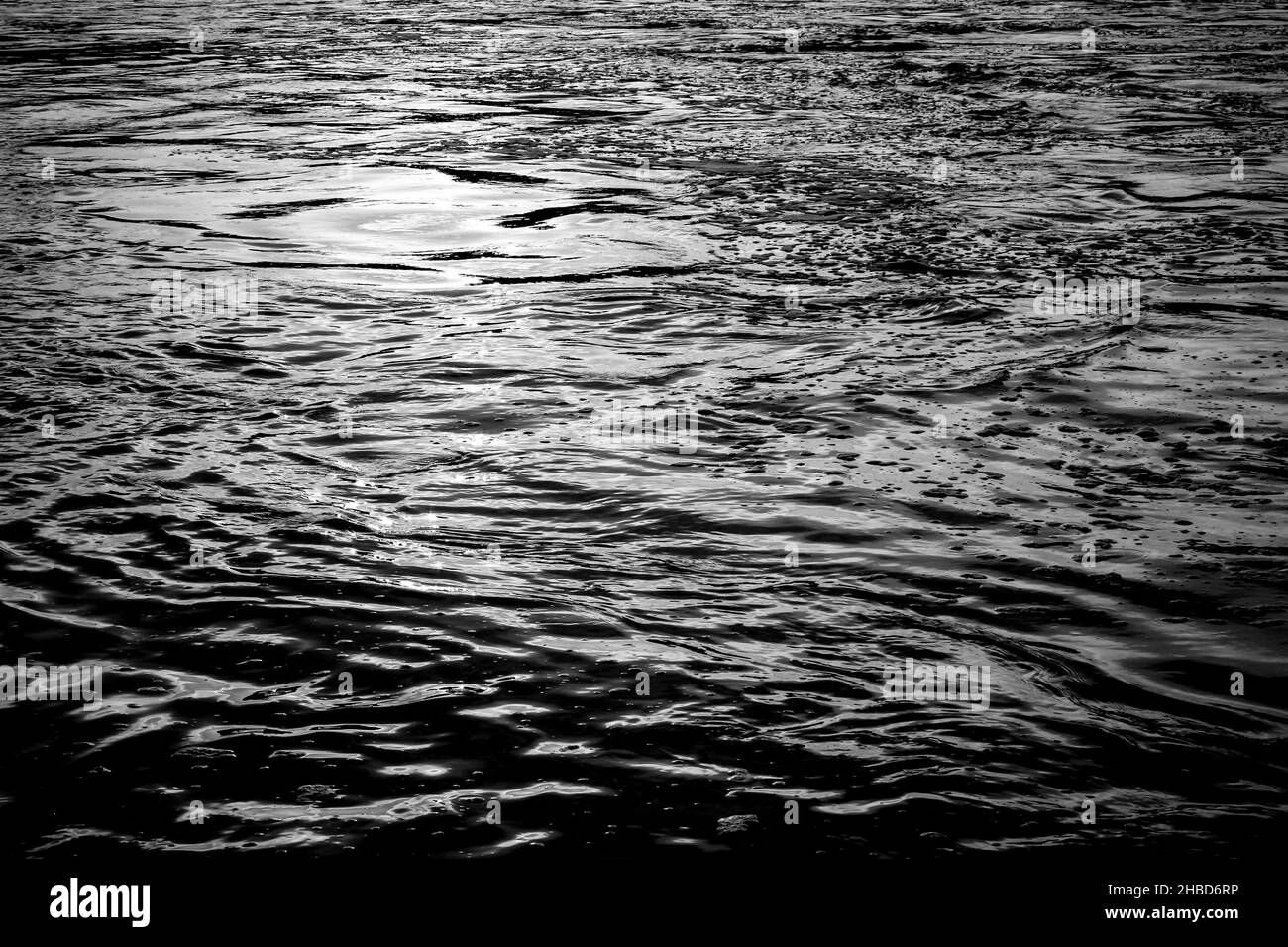 Beautiful sunlight reflections on water surface during sunset. Stock Photo