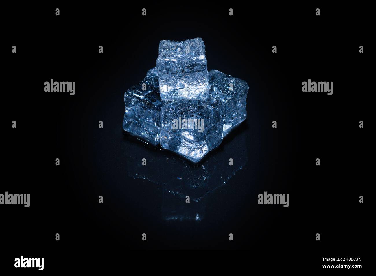 Ice crystal cubes on a black background, space for text or design. Stock Photo