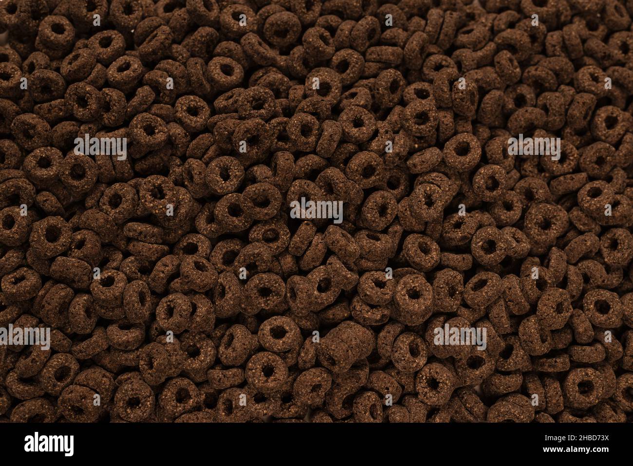 Corn-flakes background and texture. Chocolate rings. Stock Photo