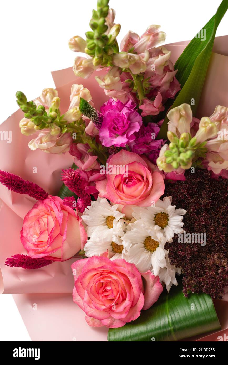 Bouquet of soft pink flowers in pink wrapping paper. Isolated on a