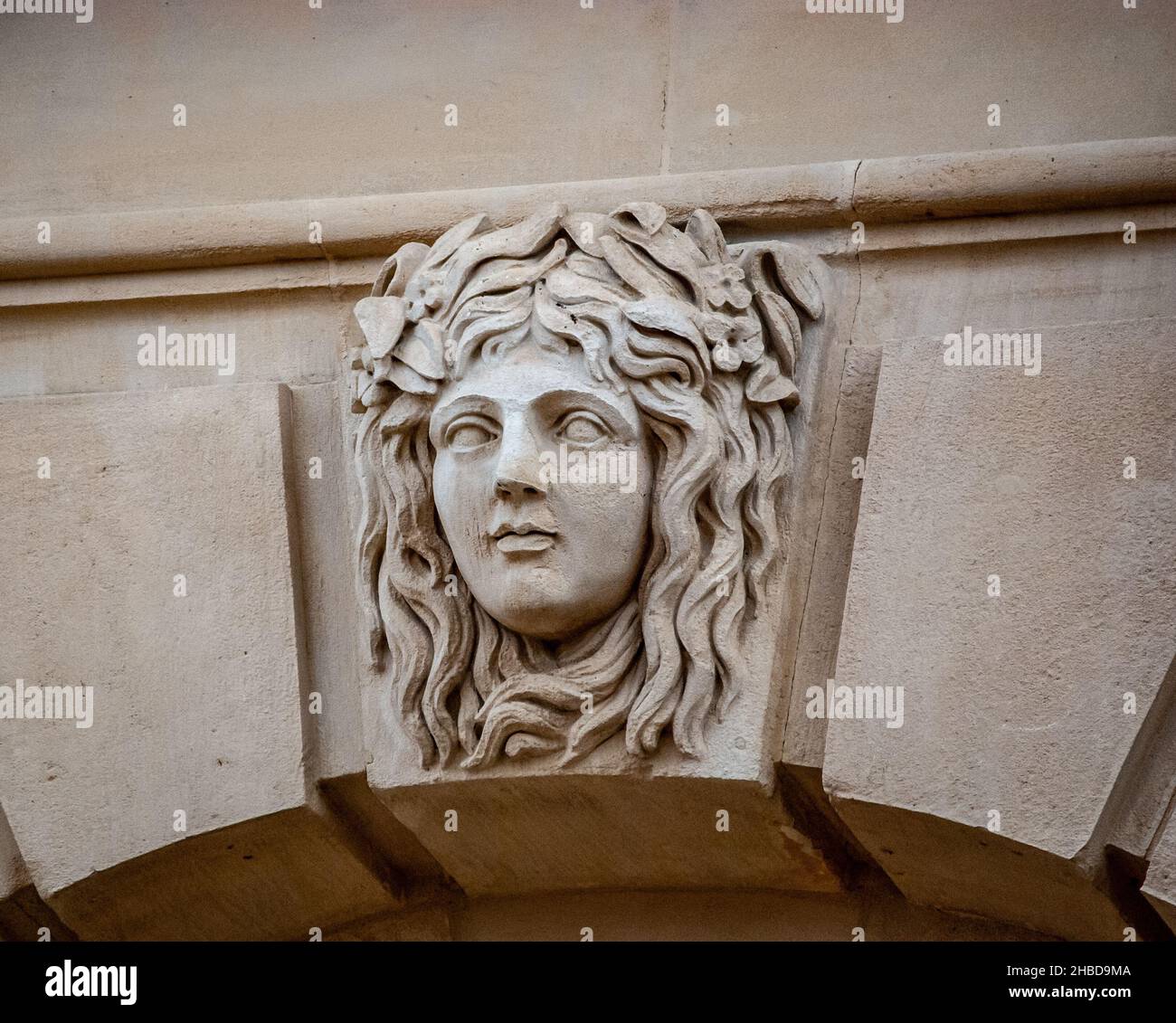 A closeup of an Ornamental Carved Stone Face of Medusa Rondanini on the facade in Paris, France Stock Photo