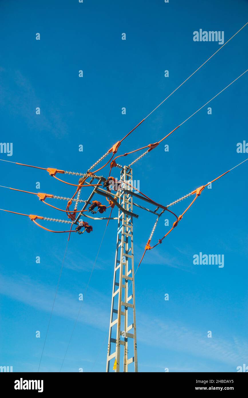 High voltage pylon against blue sky Stock Photo - Alamy