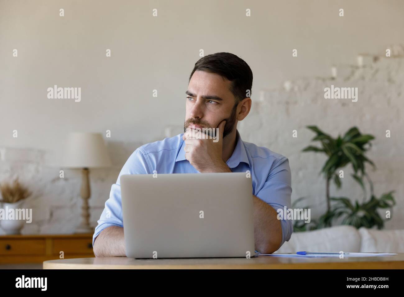 Pensive young businessman considering problem solution. Stock Photo